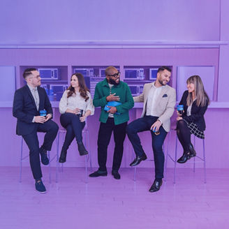 Five work collegues sitting at a bar banner light purple
