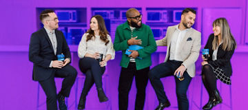 Five work collegues sitting at a bar