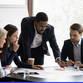 Five people discussing buisness at table