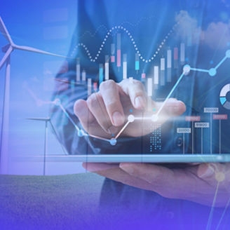 Person using a digital tablet with data charts overlaid, in front of wind turbines