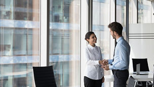 Indian woman shake hand company boss hr manager after successful job interview, client and manager handshake make deal feel satisfied. Multiracial workmates meet in office talk express respect concept