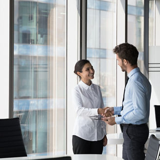 Indian woman shake hand company boss hr manager after successful job interview, client and manager handshake make deal feel satisfied. Multiracial workmates meet in office talk express respect concept