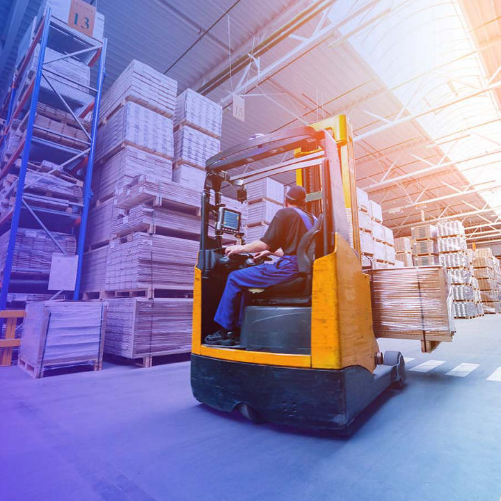 Forklift transporting wood products in warehouse banner