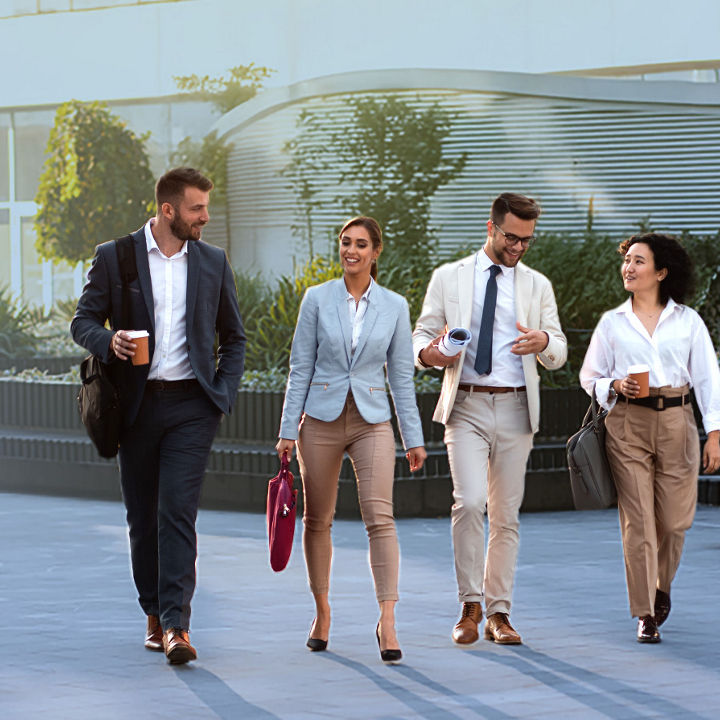 Four colleagues walking banner