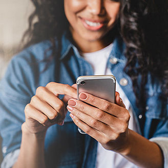 Woman typing on mobile phone