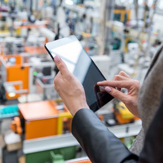 Frau tippt auf Tablett im Lager