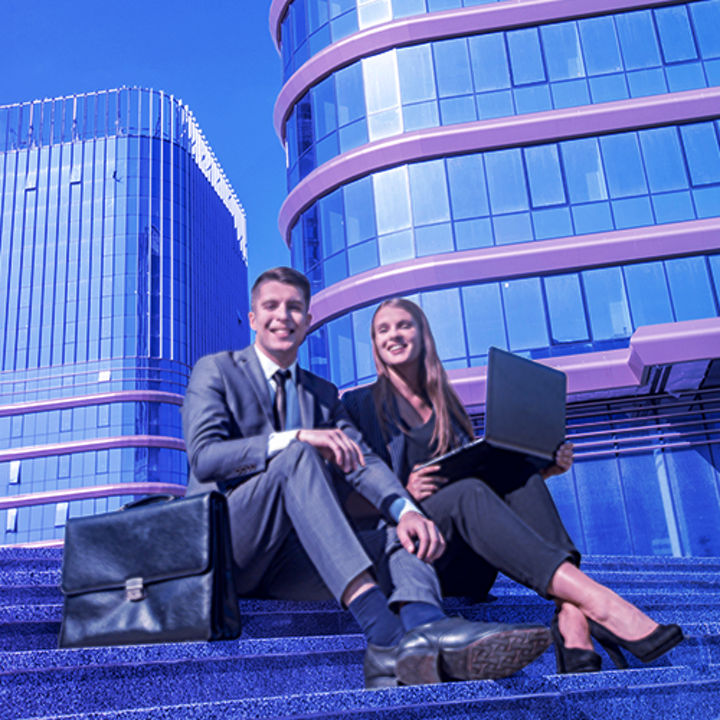 Woman and man with laptop on stairs