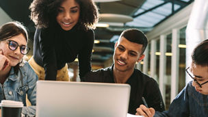 Friends having discussion near laptop