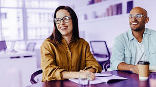 Happy business people listening to a discussion in an office. Young design professionals sitting in a team meeting.; Shutterstock ID 2379709327; purchase_order: marketing advisory assurance; job: anne rouschop; client: future of audit