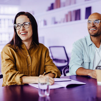 Happy business people listening to a discussion in an office. Young design professionals sitting in a team meeting.; Shutterstock ID 2379709327; purchase_order: marketing advisory assurance; job: anne rouschop; client: future of audit