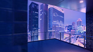 Looking out at the futuristic skyline of Osaka Japan at dusk from a residential balcony high above the city