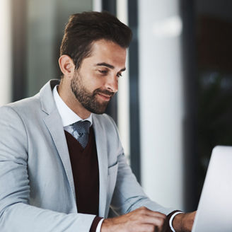 Corporate man, smile and laptop in office for productivity, research and achievement of project goals. Business employee, happy and tech in workplace for positive email, investment and revenue report.