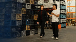 CFO of Messina Gelato and KPMG's Naomi Mitchell walking through warehouse and talking