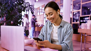 Young smiling Asian woman student using smartphone for elearning wearing earbud, watching online class webinar training in mobile app, studying, having hybrid remote video call on cell phone.; Shutterstock ID 2194984775; purchase_order: marketing advisory assurance; job: Anne rouschop; client: artificial intelligence