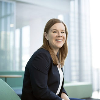 Ginger haired business woman looking at camera