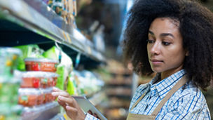 Girl fixing goods in store