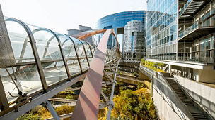 Glass bridge at front of glass building