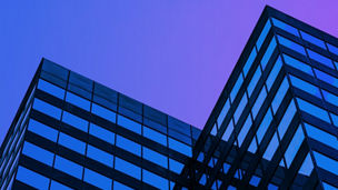 Glass building against purple sky