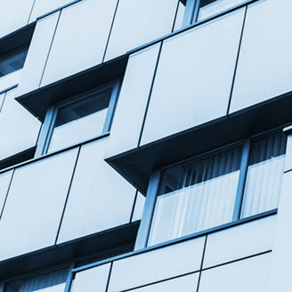 Abstract fragment of modern architecture, walls made steel with shiny windows. Blue tonal filter photo effect