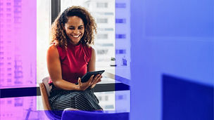 Person smiling whilst holding a tablet