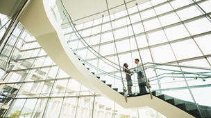 Business people talking on office staircase