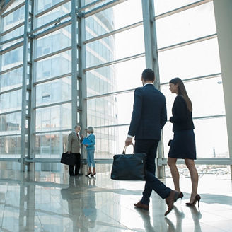 Two persons walking in an office