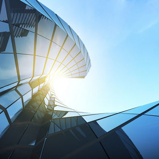 View of twisted glass building on blue sky background,Business concept of future architecture,looking up to the light on the top of building. 3d rendering.