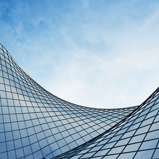 View of the clouds reflected in the curve glass office building. 3d rendering