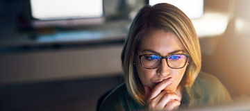 Shot of a young businesswoman working late on a computer in an office