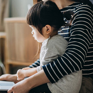 Child sitting on mother's lap banner with gradient