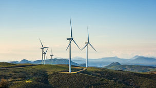 Wind turbines on a beautiful blue sky in a mountain wind farm in Sardinia. Renewable energy concept, green energy generation. Energy industry.