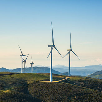 Wind turbines on a beautiful blue sky in a mountain wind farm in Sardinia. Renewable energy concept, green energy generation. Energy industry.