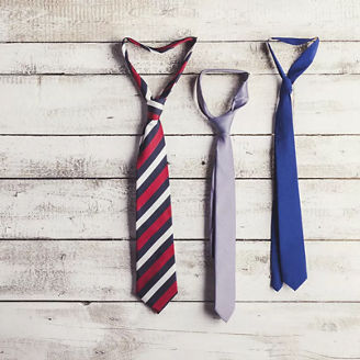 Ties hanging from wooden wall