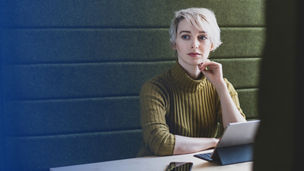 woman sitting on a desk wearing a zhivago