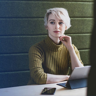 woman sitting on a desk wearing a zhivago