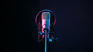Studio microphone and pop shield on mic in the empty recording studio with copy space. Performance and show in the music business equipment.