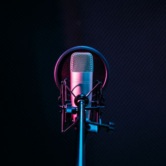 Studio microphone and pop shield on mic in the empty recording studio with copy space. Performance and show in the music business equipment.