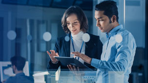 co-workers discussing while holding a tablet device
