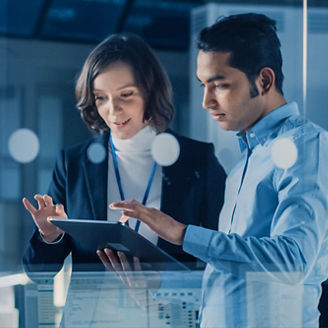 co-workers discussing while holding a tablet device