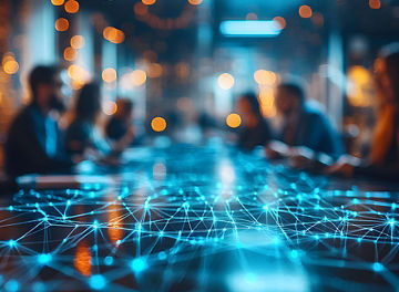 Focused business meeting at a roundtable, abstract network background softly blurred to emphasize teamwork