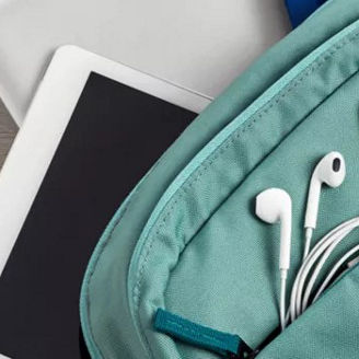 green-school-bag-with-tablet-mobile-phone-notebook-pen-and-earphones