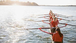 Rowing team in scull on sunny river