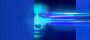 A person wearing business attire and glasses standing next to a tall glass building