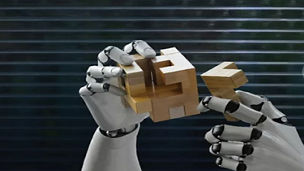 Hands of robot joining wooden pieces