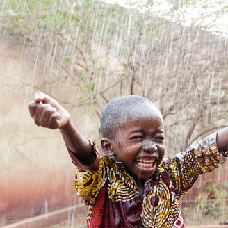 Happy child in a rain