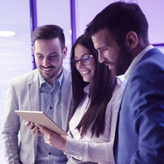 Three persons watching a tablet