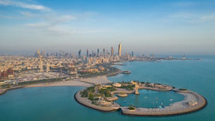 A high-angle shot of The Green Island with a skyline of the city of Kuwait in the background