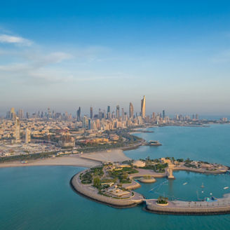 A high-angle shot of The Green Island with a skyline of the city of Kuwait in the background