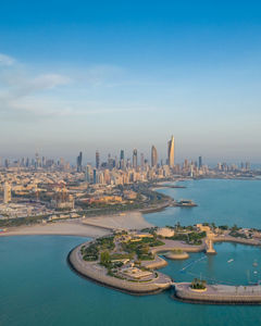 A high-angle shot of The Green Island with a skyline of the city of Kuwait in the background