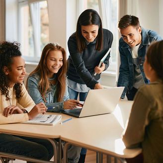 Diverse group of high school students gathered around a laptop